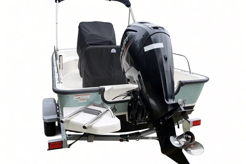 Slide: The Image of 2017 Boston Whaler 170 Montauk boat with outboard motor on trailer. - 30
