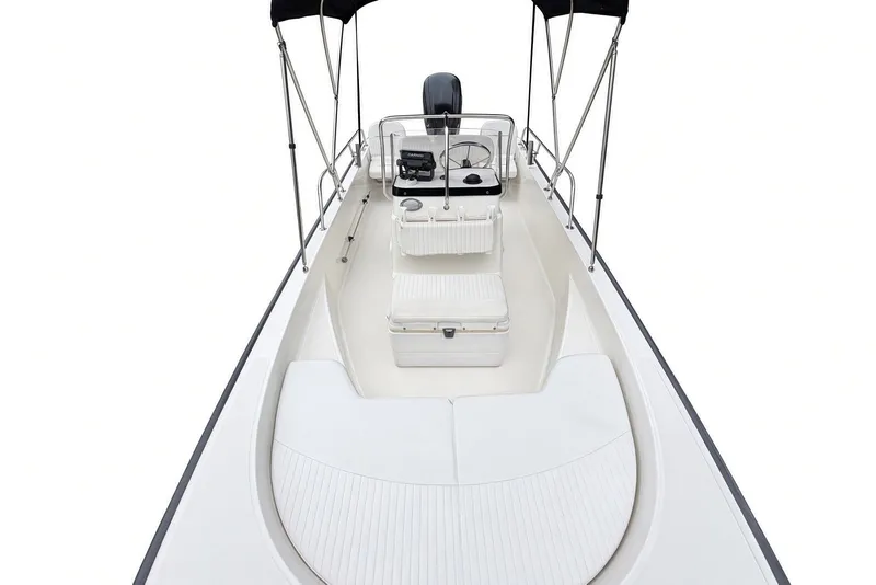Slide: The Image of 2017 Boston Whaler 170 Montauk boat interior with seating and console, featuring a sleek design. - 10