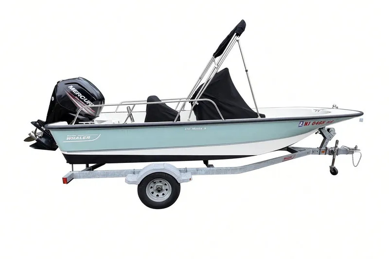 Slide: The Image of 2017 Boston Whaler 170 Montauk boat on trailer with Mercury outboard motor. - 32