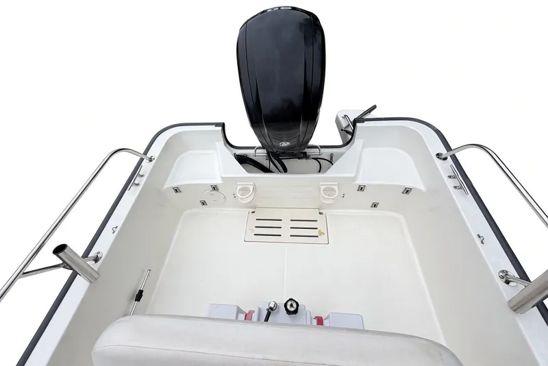 Slide: The Image of 2017 Boston Whaler 170 Montauk boat interior with motor and seating area. - 16