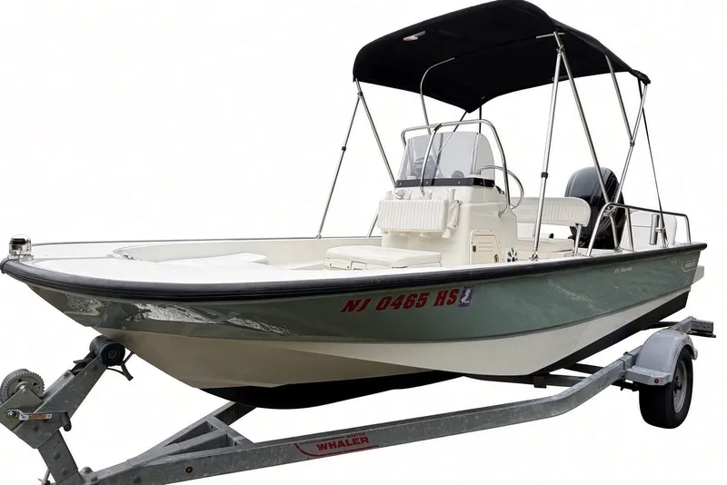 Slide: The Image of 2017 Boston Whaler 170 Montauk boat on trailer with canopy and registration number. - 9