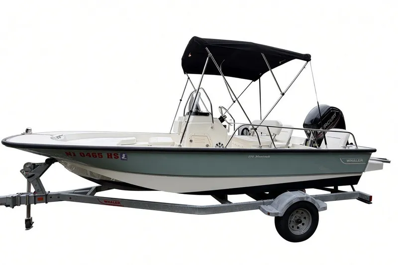 Slide: The Image of 2017 Boston Whaler 170 Montauk boat on trailer with canopy and outboard motor. - 6