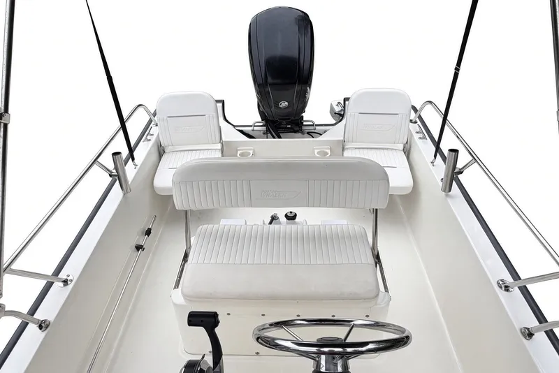 Slide: The Image of 2017 Boston Whaler 170 Montauk boat interior with seating and steering wheel. - 13