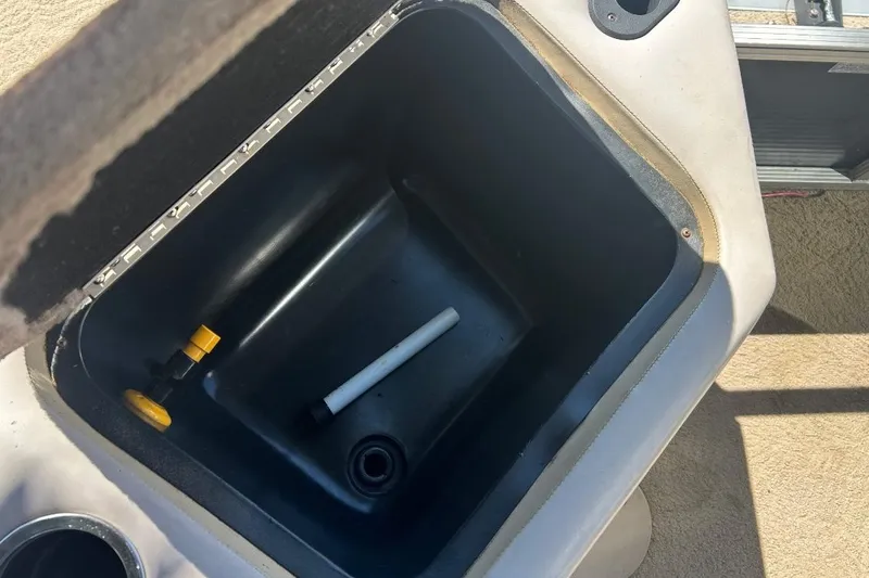 Slide: The Image of Open storage compartment on a 2011 Bennington 24 SFi boat, showing interior details. - 23