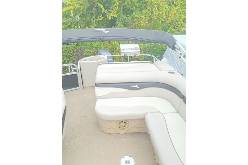 Slide: The Image of 2011 Bennington 24 SFi pontoon boat interior with plush seating and canopy. - 16