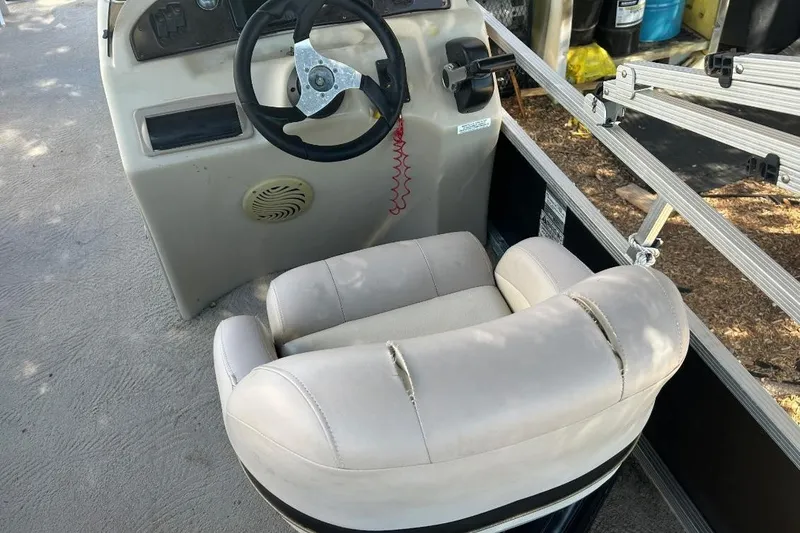 Slide: The Image of Steering console of a 2011 Bennington 24 SFi boat with a worn captain's chair. - 13