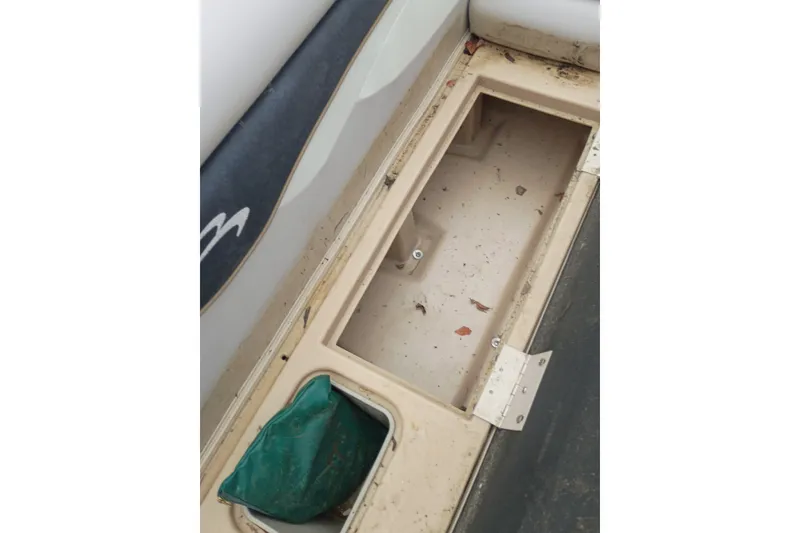Slide: The Image of Open storage compartment on a 2011 Bennington 24 SFi boat, showing interior details. - 13