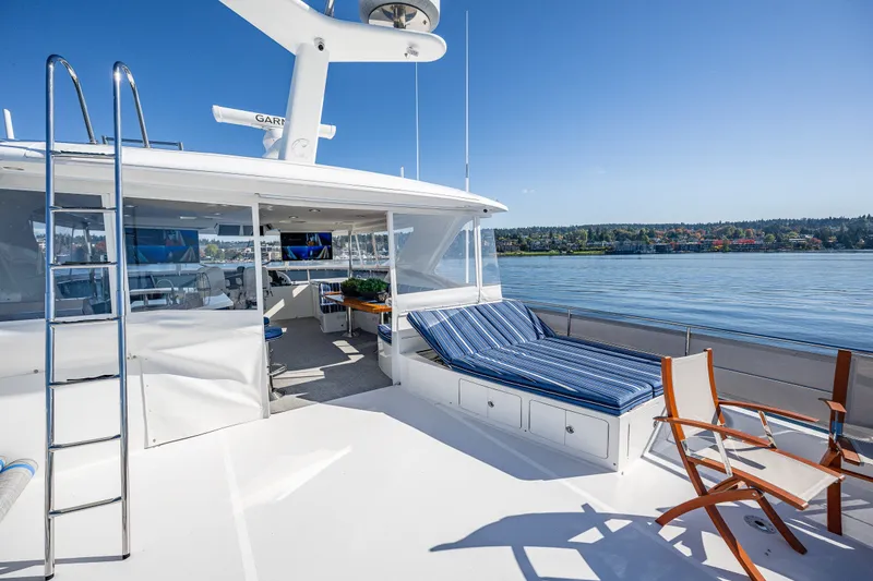 Slide: The Image of Luxurious 2012 Ocean Alexander 85 E yacht deck with seating, overlooking serene waters. - 73