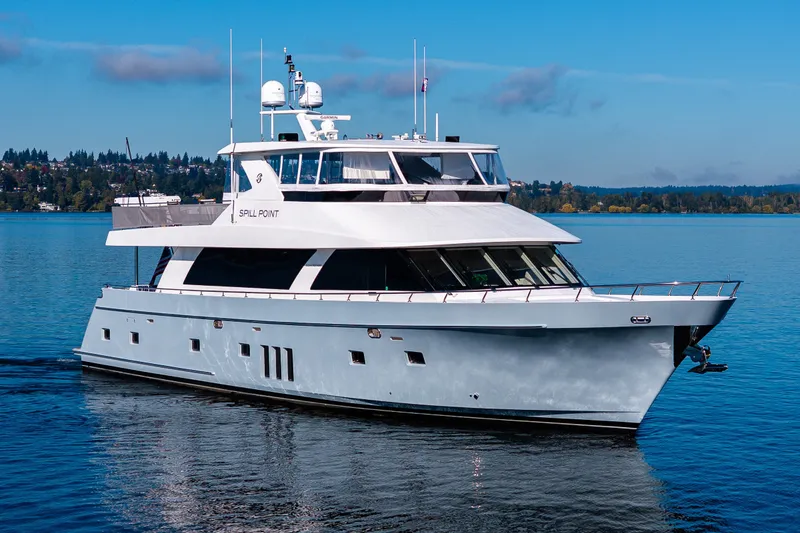 Slide: The Image of Luxury 2012 Ocean Alexander 85 E yacht cruising on a serene lake. - 16