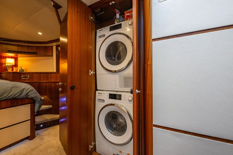 Slide: The Image of Laundry area with stacked washer and dryer in 2012 Ocean Alexander 85 E yacht. - 51