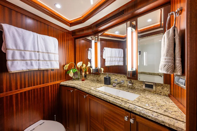 Slide: The Image of Luxurious bathroom in 2012 Ocean Alexander 85 E yacht with granite countertop and elegant wood paneling. - 47