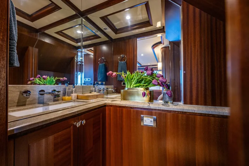 Slide: The Image of Luxurious bathroom on 2012 Ocean Alexander 85 E yacht with elegant wood finishes and floral decor. - 60