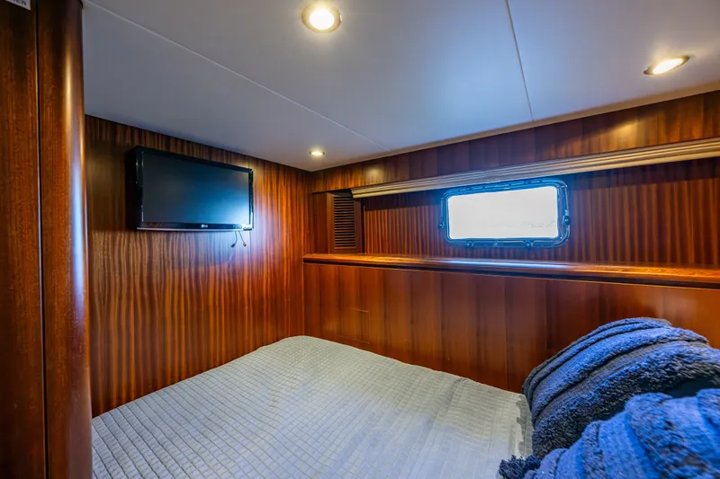Slide: The Image of Luxurious cabin interior of 2012 Ocean Alexander 85 E yacht with wood paneling and TV. - 70