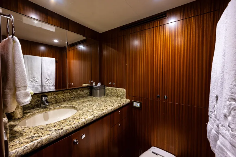 Slide: The Image of Luxurious bathroom in 2012 Ocean Alexander 85 E yacht with granite countertop and wood paneling. - 94