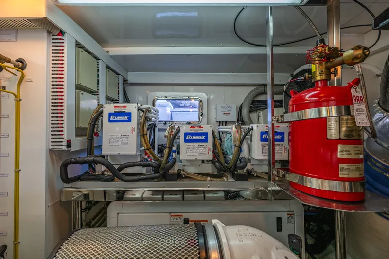 Slide: The Image of Engine room of 2012 Ocean Alexander 85 E yacht with machinery and fire extinguisher. - 108