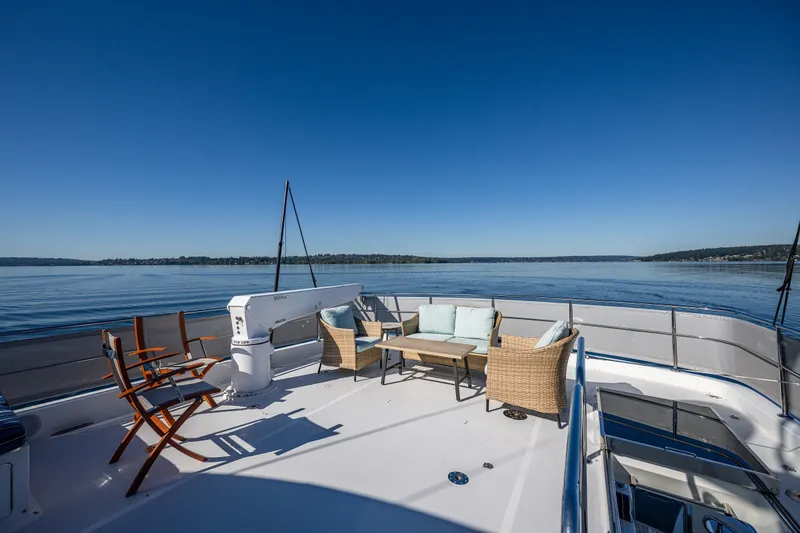 Slide: The Image of Luxurious deck of 2012 Ocean Alexander 85 E yacht with seating, overlooking serene waters. - 75
