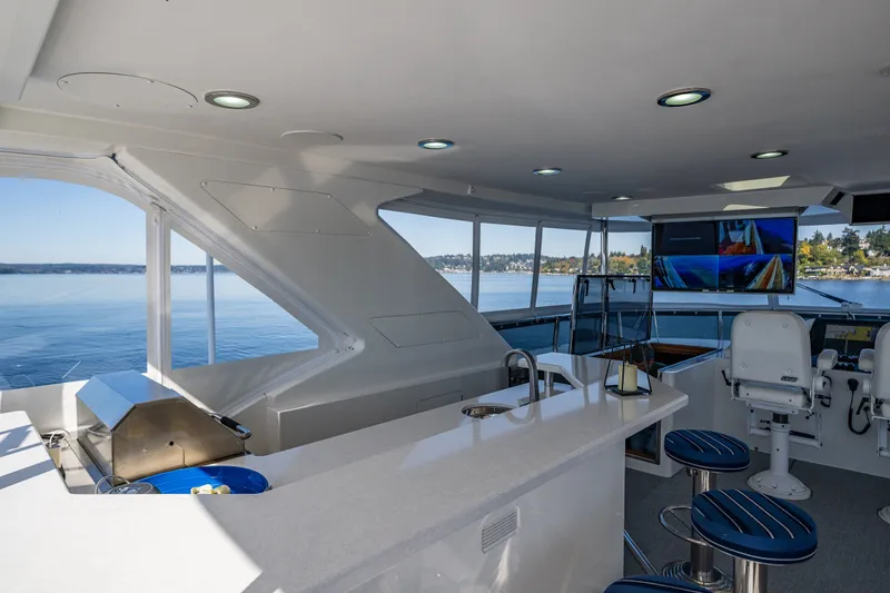 Slide: The Image of Luxurious 2012 Ocean Alexander 85 E yacht interior with bar, seating, and scenic water views. - 86