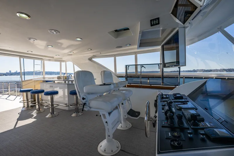 Slide: The Image of Luxurious 2012 Ocean Alexander 85 E yacht helm with modern controls and seating. - 80