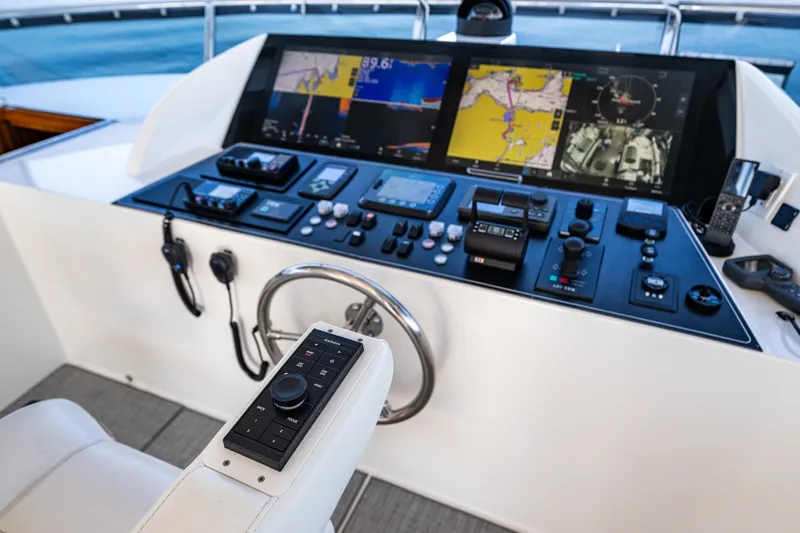 Slide: The Image of Control panel of 2012 Ocean Alexander 85 E yacht with navigation screens and controls. - 92