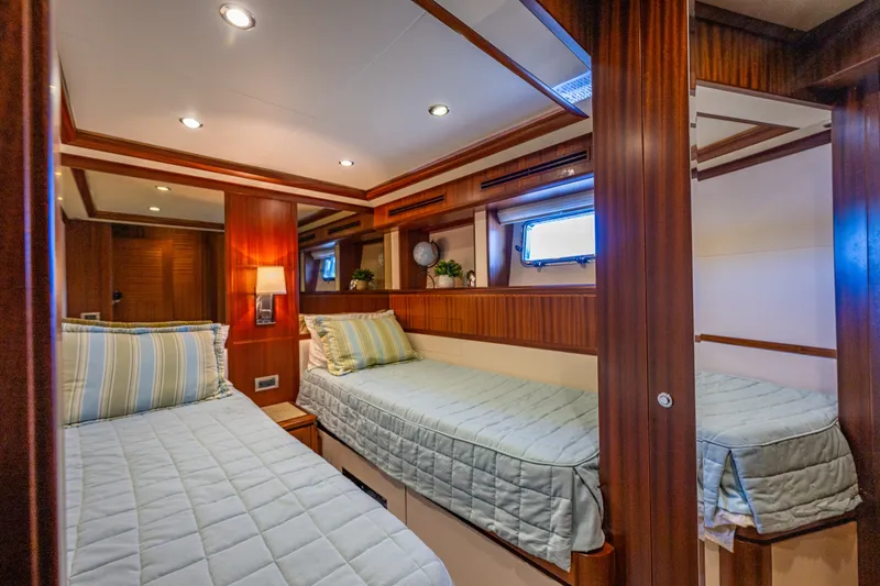 Slide: The Image of Luxurious twin cabin interior of 2012 Ocean Alexander 85 E yacht, featuring elegant wood finishes. - 55