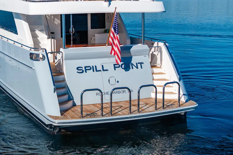 Slide: The Image of Luxury yacht Ocean Alexander 85 E, 2012 model, docked with American flag displayed. - 15