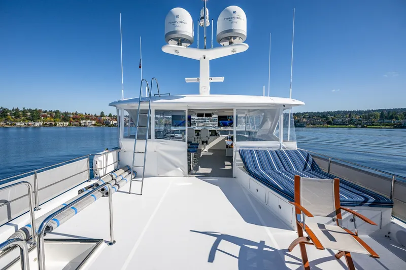 Slide: The Image of Luxurious 2012 Ocean Alexander 85 E yacht deck with seating, overlooking serene waters. - 71
