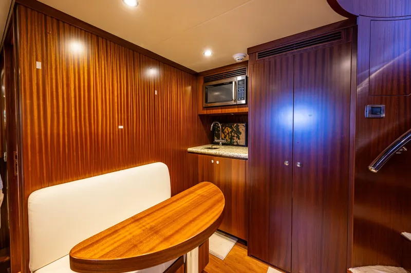 Slide: The Image of Luxurious interior of 2012 Ocean Alexander 85 E yacht with wood paneling and kitchenette. - 63
