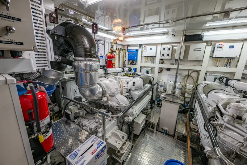 Slide: The Image of Engine room of 2012 Ocean Alexander 85 E yacht, featuring advanced machinery and control systems. - 104