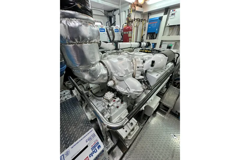 Slide: The Image of Engine room of 2012 Ocean Alexander 85 E yacht, featuring a powerful marine engine. - 111