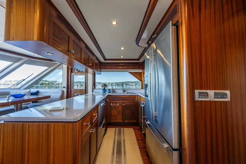 Slide: The Image of Galley of Ocean Alexander 85 E yacht with wood cabinetry and modern appliances. - 28