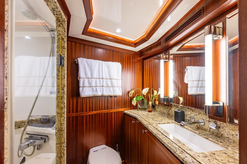 Slide: The Image of Luxurious bathroom on 2012 Ocean Alexander 85 E yacht with granite countertops and wood paneling. - 54