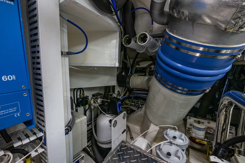 Slide: The Image of Engine room of 2012 Ocean Alexander 85 E yacht, featuring complex machinery and piping. - 109