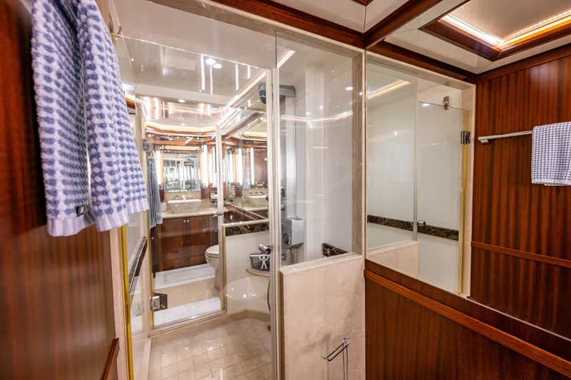 Slide: The Image of Luxurious bathroom on 2012 Ocean Alexander 85 E yacht with wood accents and glass shower. - 41