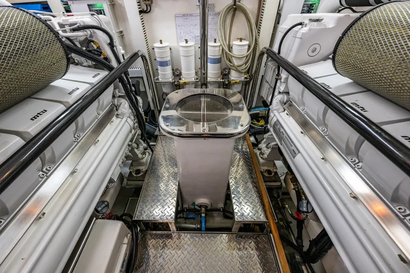 Slide: The Image of Engine room of 2012 Ocean Alexander 85 E yacht, featuring MTU engines and metallic flooring. - 106