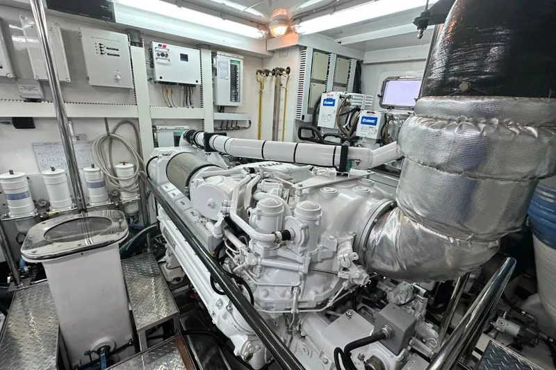 Slide: The Image of Engine room of a 2012 Ocean Alexander 85 E yacht, showcasing advanced machinery and equipment. - 105