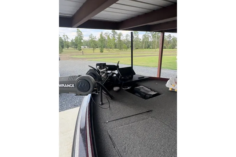 Slide: The Image of 2022 Nitrio Z20 PRO boat under shelter with fishing equipment and scenic background. - 1