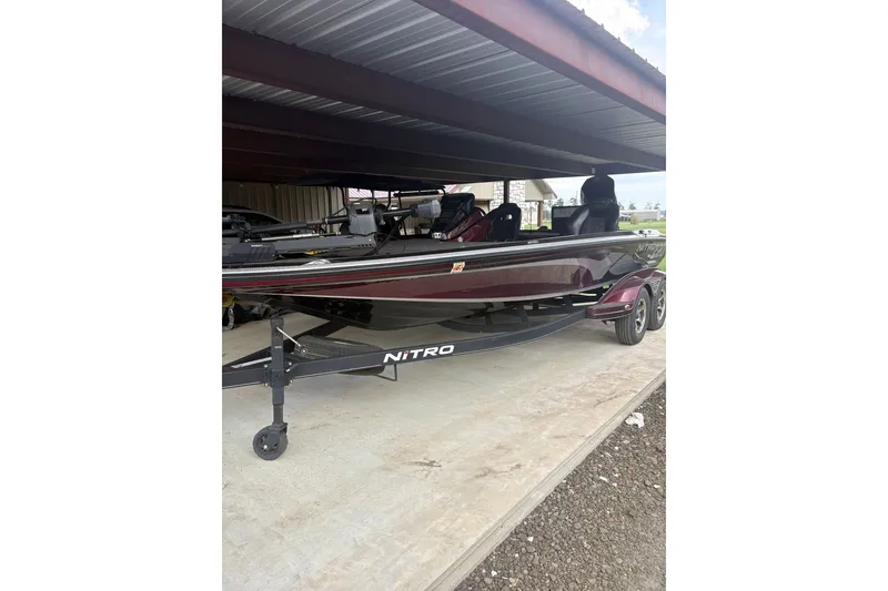 Slide: The Image of 2022 Nitrio Z20 PRO boat parked under a metal shelter. - 5