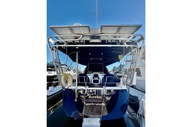 Slide: The Image of 2007 Jeanneau Sun Odyssey 49 DS yacht with solar panels, docked in a marina. - 9