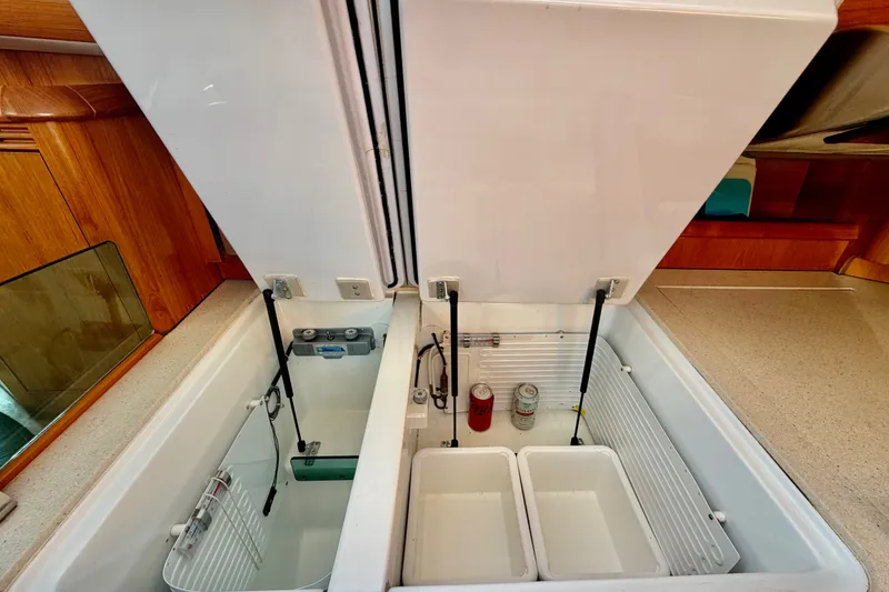 Slide: The Image of Open refrigerator compartments on a 2007 Jeanneau Sun Odyssey 49 DS yacht. - 87