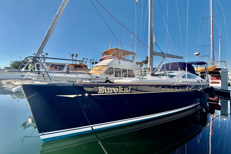 The Image of 2007 Jeanneau Sun Odyssey 49 DS sailboat docked in marina, clear blue sky. - 1