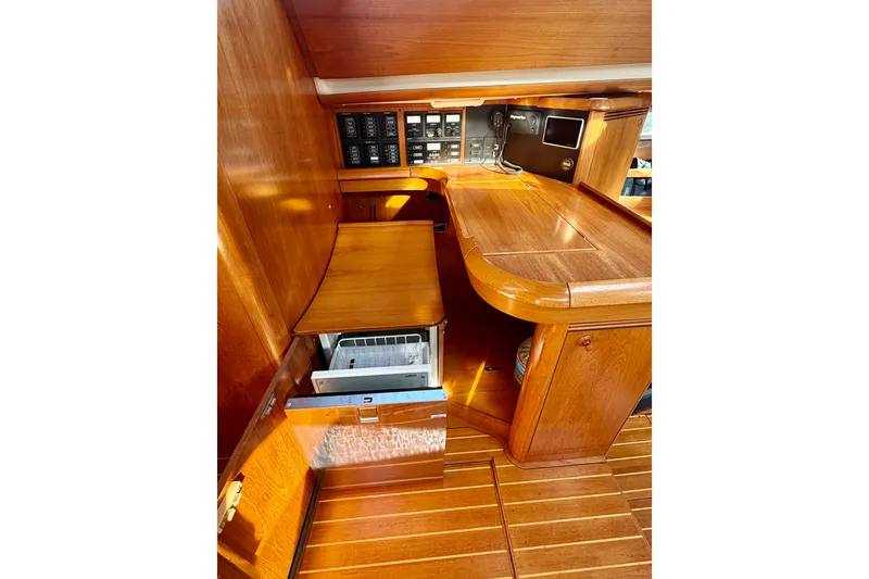 Slide: The Image of 2007 Jeanneau Sun Odyssey 49 DS interior with wooden cabinetry and navigation controls. - 78