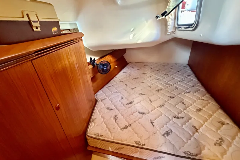 Slide: The Image of Cozy cabin interior of 2007 Jeanneau Sun Odyssey 49 DS with mattress and wooden cabinetry. - 89