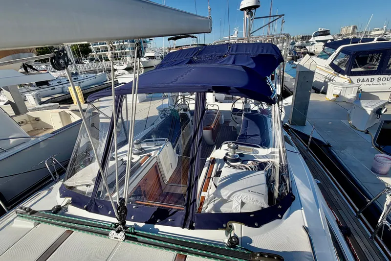 Slide: The Image of 2007 Jeanneau Sun Odyssey 49 DS sailboat docked at marina, featuring blue canopy and clear panels. - 41