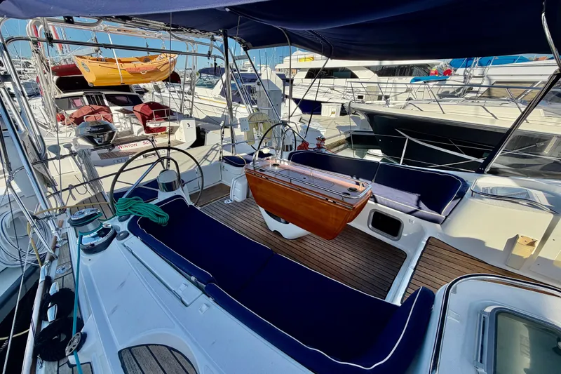 Slide: The Image of Cockpit of 2007 Jeanneau Sun Odyssey 49 DS yacht, featuring dual steering wheels and seating. - 42