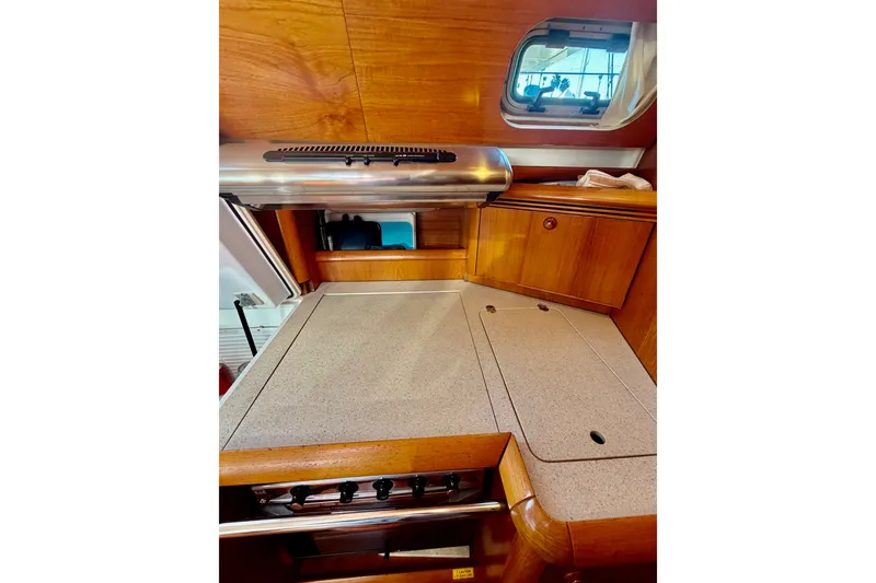 Slide: The Image of Interior galley of 2007 Jeanneau Sun Odyssey 49 DS yacht with wooden cabinetry. - 99
