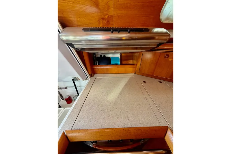 Slide: The Image of 2007 Jeanneau Sun Odyssey 49 DS yacht kitchen with wooden cabinetry and stainless steel appliances. - 88