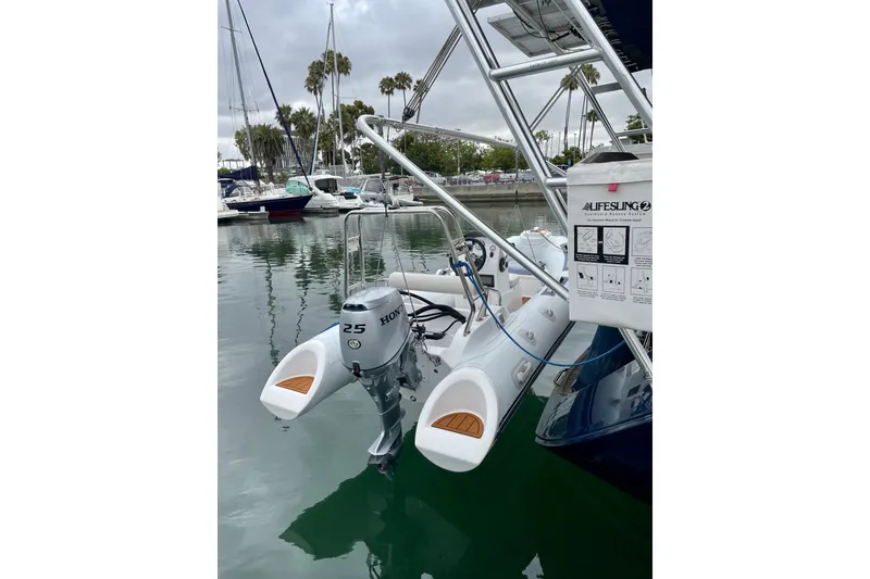 Slide: The Image of Jeanneau Sun Odyssey 49 DS (2007) with Honda outboard motor in marina setting. - 51