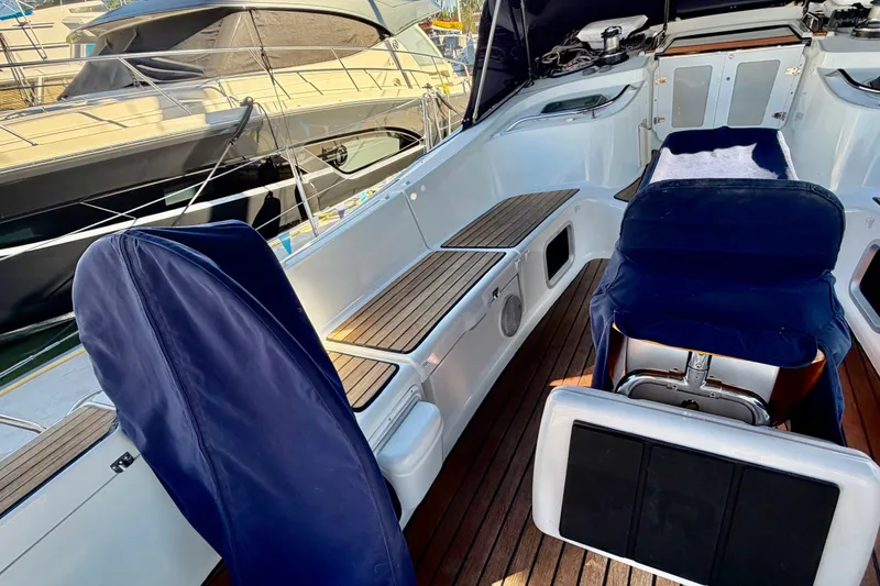 Slide: The Image of Cockpit of 2007 Jeanneau Sun Odyssey 49 DS with blue seating and wooden flooring. - 15