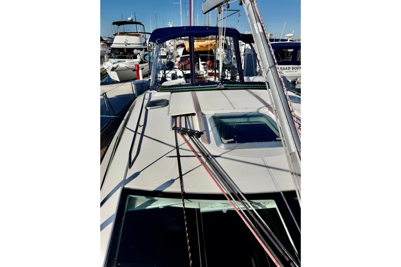 Slide: The Image of 2007 Jeanneau Sun Odyssey 49 DS sailboat docked at marina, showcasing deck and rigging. - 39