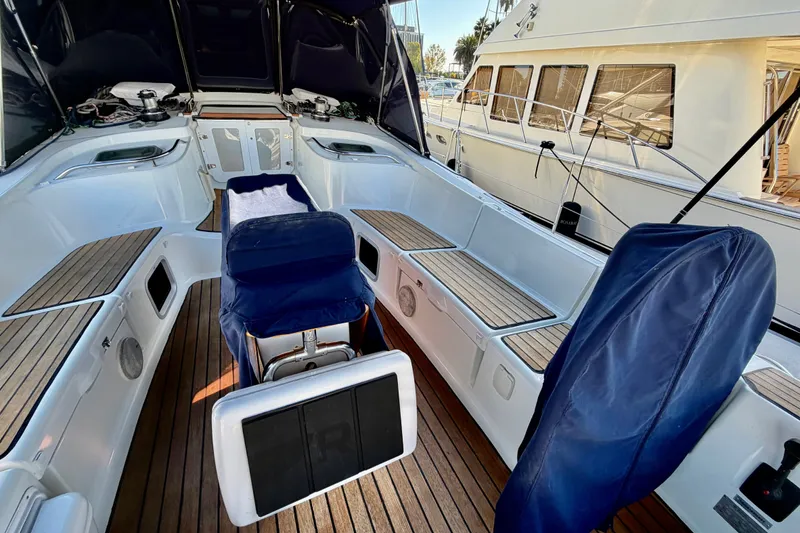 Slide: The Image of Cockpit of 2007 Jeanneau Sun Odyssey 49 DS with teak flooring and covered seating. - 14
